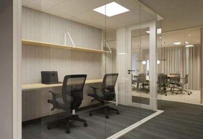 Bright internal workstation pod with mesh chairs and glass partitions.