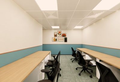 Modern workspace with long rows of desks and ergonomic chairs.