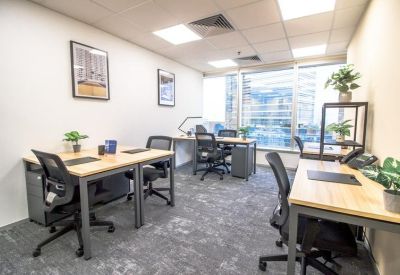 Four-person office suite with light wood desks and framed wall art.