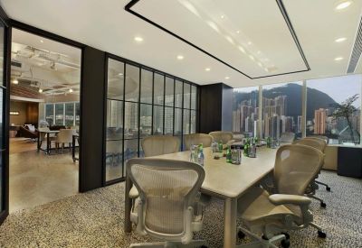 Professional meeting room with a large table, ergonomic chairs, and expansive window views.