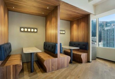 Two private wooden booths with leather seating and built-in lighting.