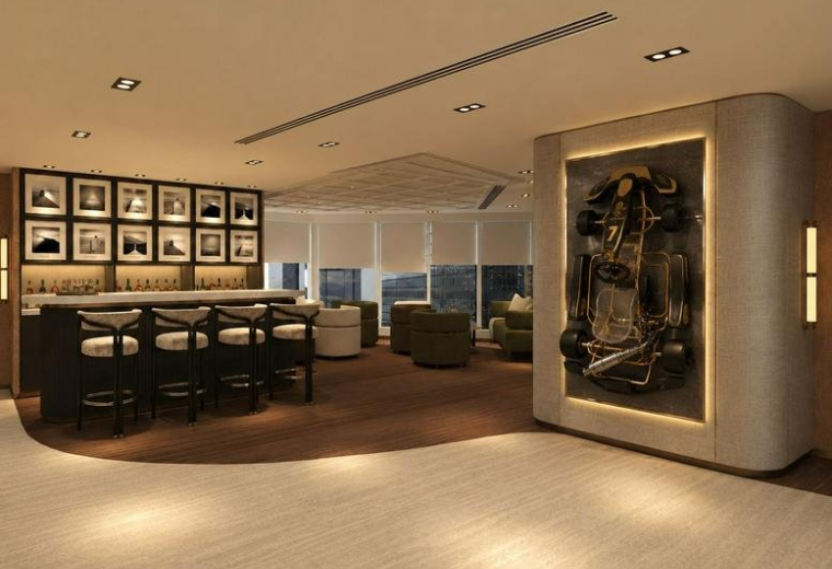 Spacious lounge area at Tower One, Lippo Centre featuring a bar, racing-themed wall art, and warm lighting.