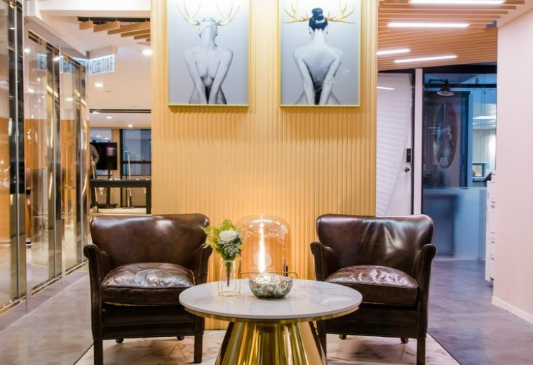 Reception area at 3/F Eton Tower featuring leather armchairs and contemporary artwork.