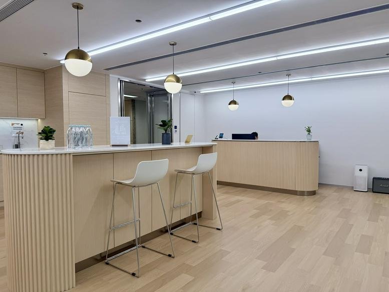 Modern reception area at 27/F, 1111 King's Road, Taikoo Shing featuring light wood tones and pendant lighting.