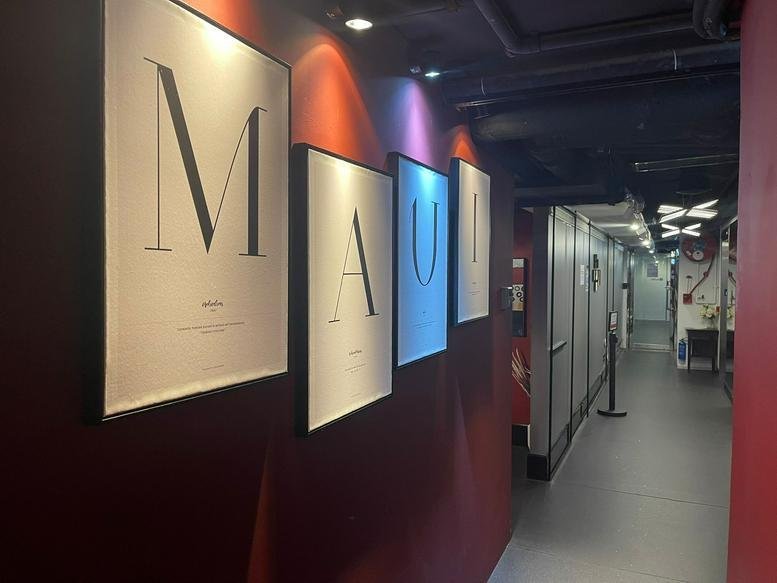 A stylish hallway with large framed typography art and warm mood lighting at 2/F Eton Tower.