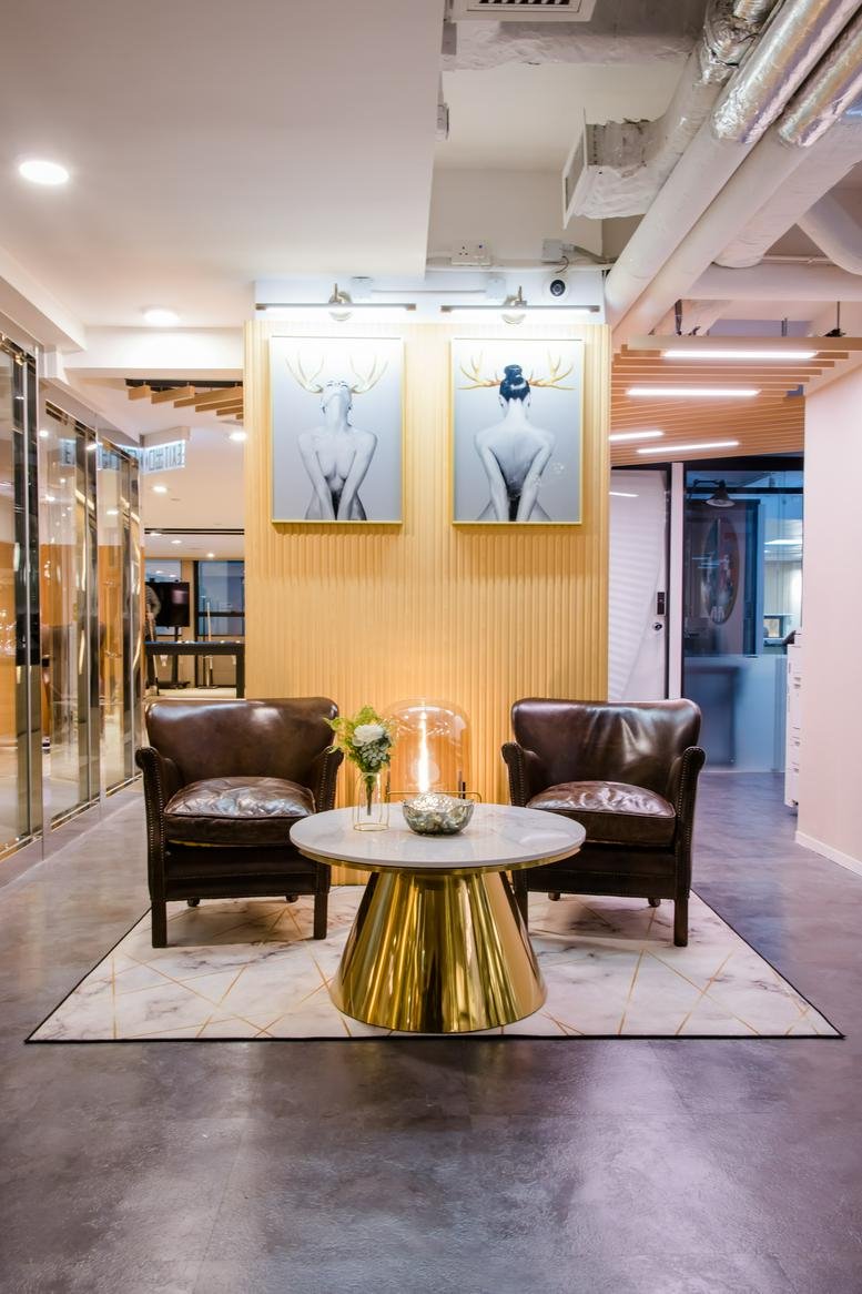 Reception area at 3/F Eton Tower featuring leather armchairs and contemporary artwork.