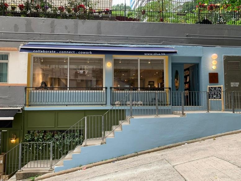 Exterior view of the blue-fronted 1 Electric Street, Shop 1A building with a striped awning.