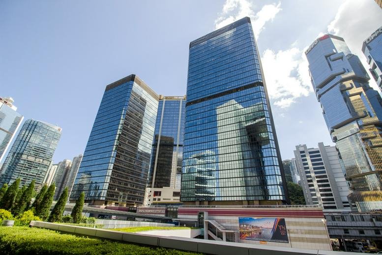 Exterior view of the blue glass skyscrapers of 15/F Admiralty Centre Tower 1 under a bright sky.