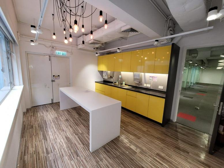 Spacious lounge area at Hong Kong Spinners Industrial Building Phase 5 featuring a curved orange sofa.
