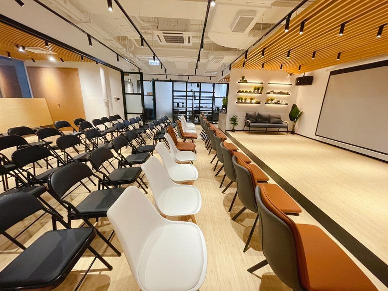 Spacious presentation room at 2601-05, Delta House with tiered seating and a large projector screen.