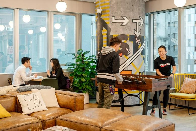 Spacious communal lounge at 33 Lockhart Road, Wan Chai, Hong Kong with foosball and leather sofas.