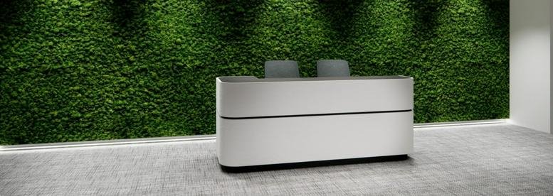Reception desk at Dah Sing Financial Centre with a lush green moss feature wall.