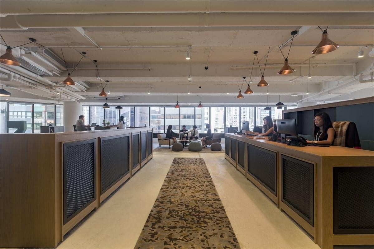 Wide view of the reception area and waiting lounge with city skyline views.