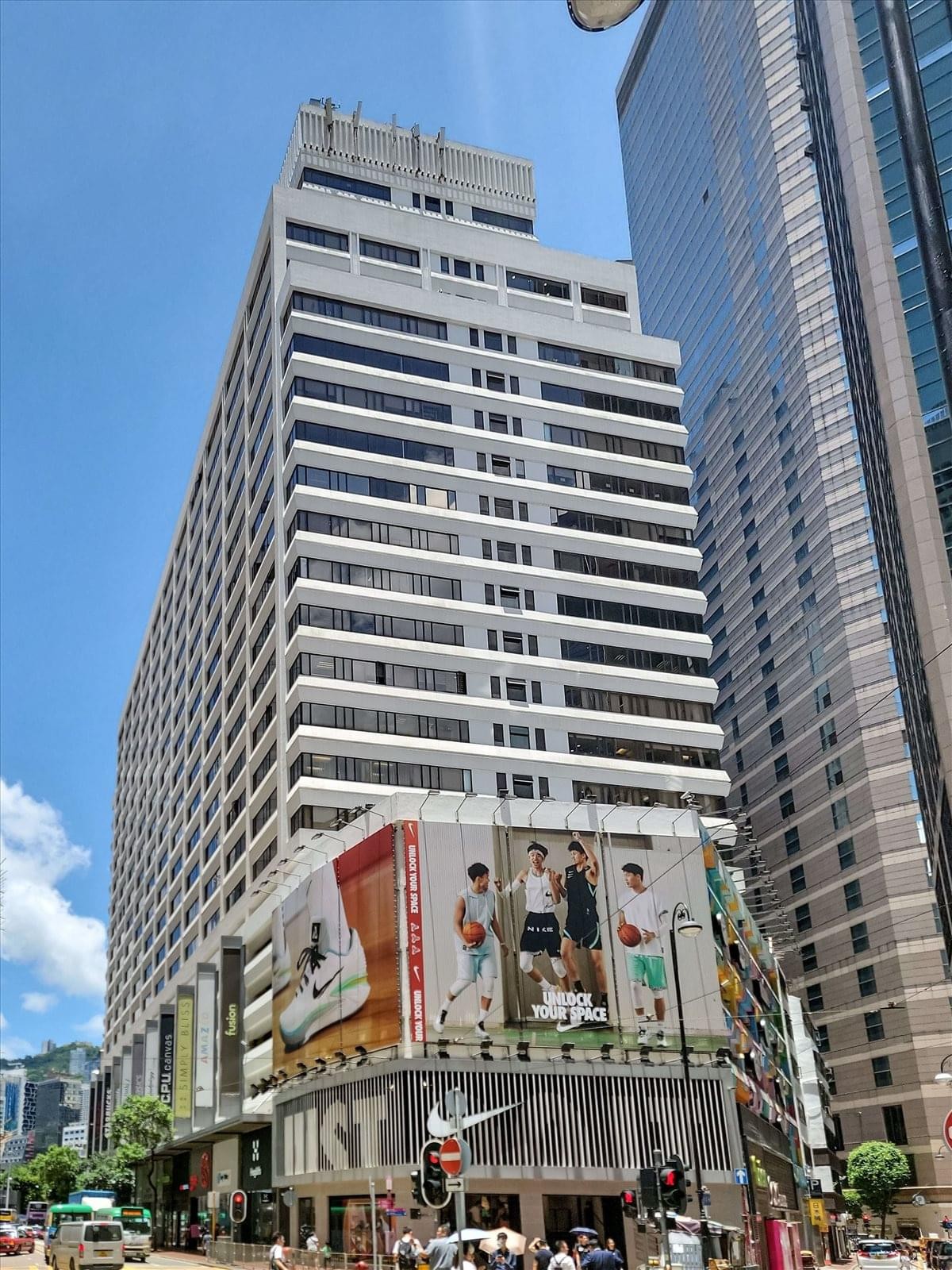 Exterior view of the white multi-story Leighton Centre building under a clear blue sky.