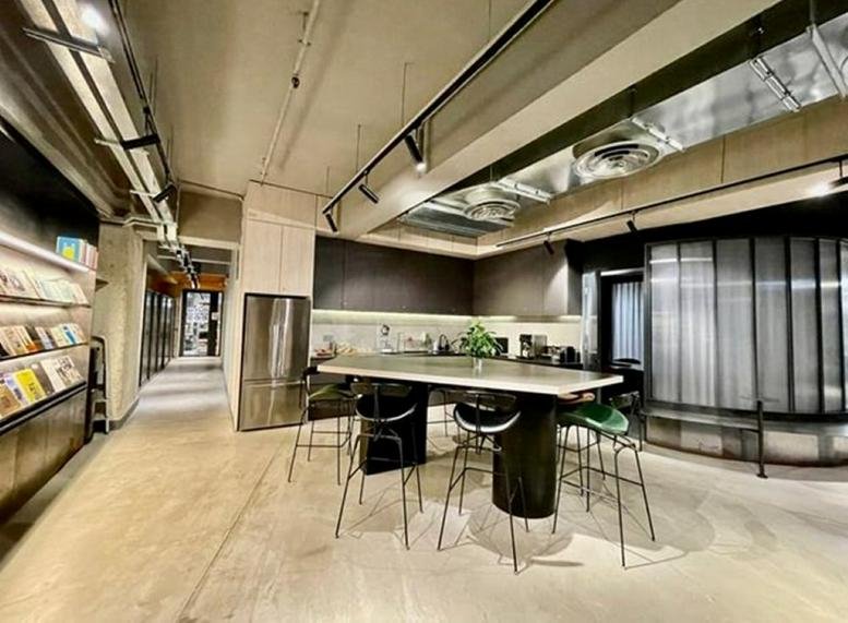 Spacious communal break area at Shield Industrial Centre with high-top tables and exposed industrial ceilings.