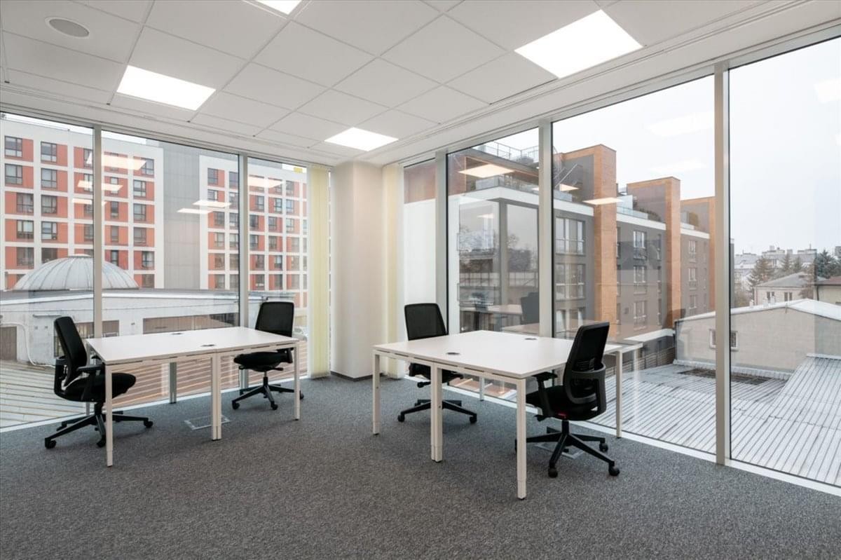 Spacious private office with desks and panoramic city views at International Commerce Centre.
