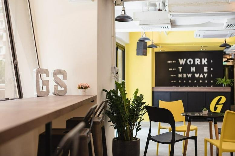 Bright reception area at Beverly House, 93-107 Lockhart Road, with yellow accents and a coffee bar.