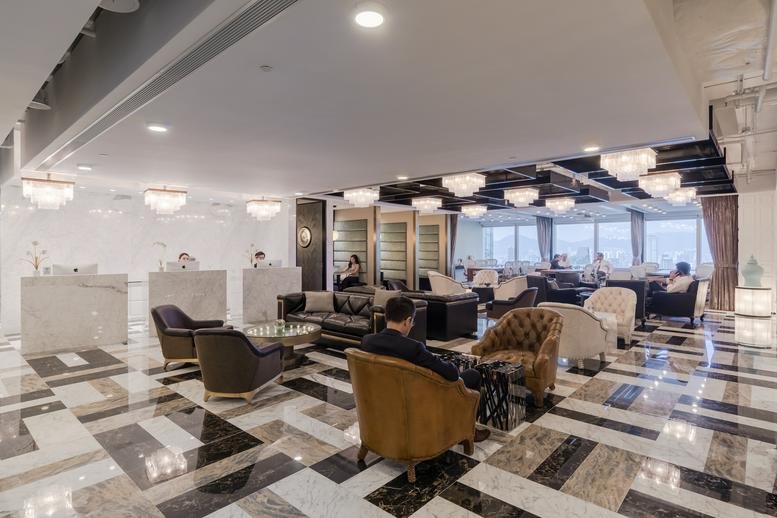Spacious marble-floored reception area at Champion Tower, 3 Garden Road, with elegant lounge seating.