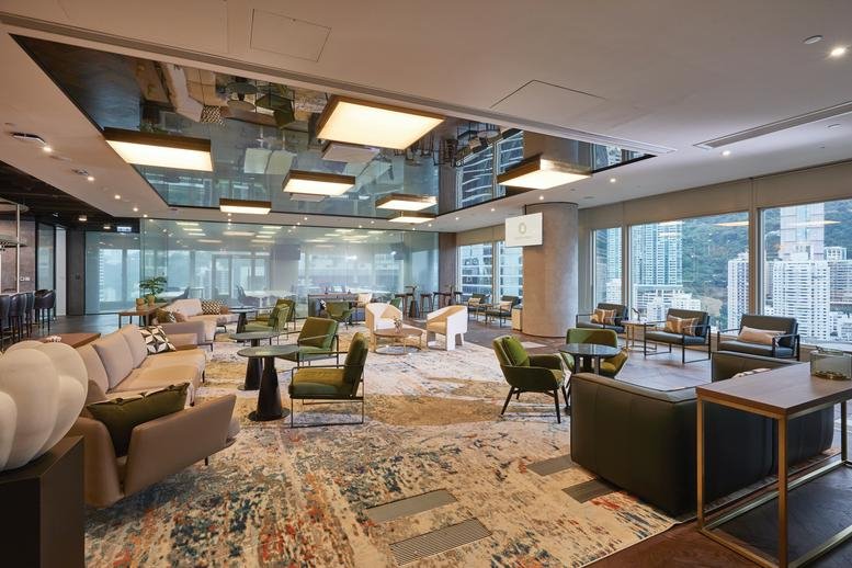 Spacious communal lounge at Cheung Kong Center with designer seating and reflective ceiling.