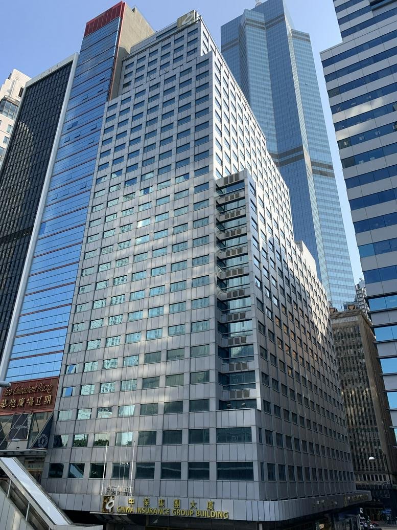 Wide exterior view of the grey facade at the China Insurance Group Building.