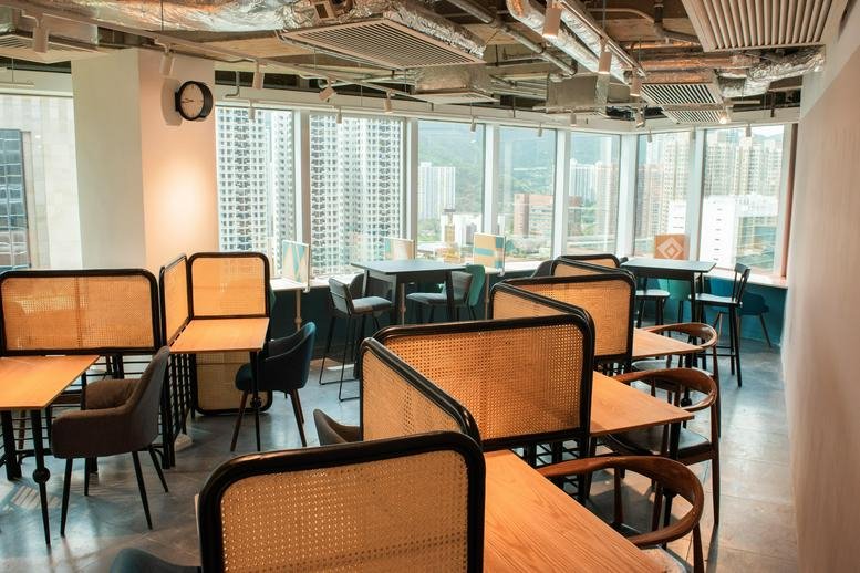 Spacious coworking lounge at Grand Central Plaza Tower 1 with natural light and views of the city skyline.