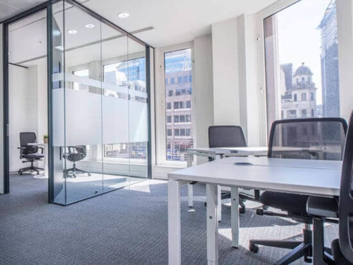 Spacious open-plan workspace at Grand Century Place with floor-to-ceiling windows and glass partitions.