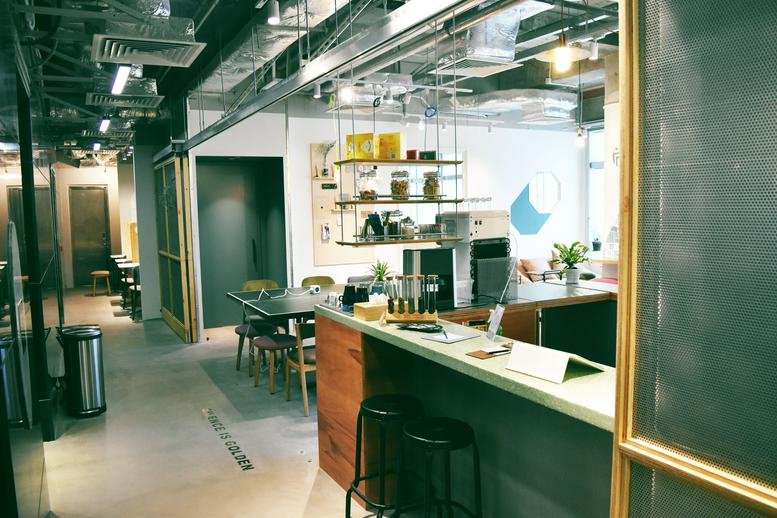 Spacious communal lounge and cafe area at Hang Seng Tsuen Wan Building with a modern industrial design.