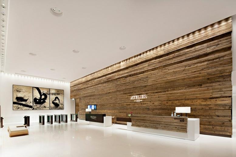 Grand lobby at K11 Atelier featuring a high-ceilinged rustic wood-slat feature wall.