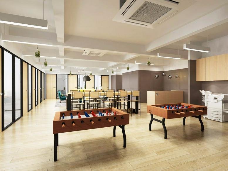 Spacious communal breakout area at Kwai Bo Industrial Building with foosball tables and dining area.
