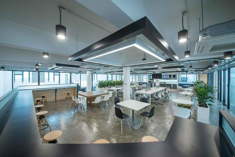 Spacious communal coworking area at Lai Cheong Factory Building with varied seating and natural light.