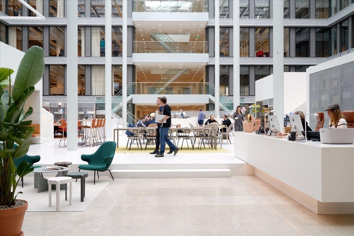 Spacious multi-story atrium at Lan Kwai Fong Tower with lounge seating and natural light.