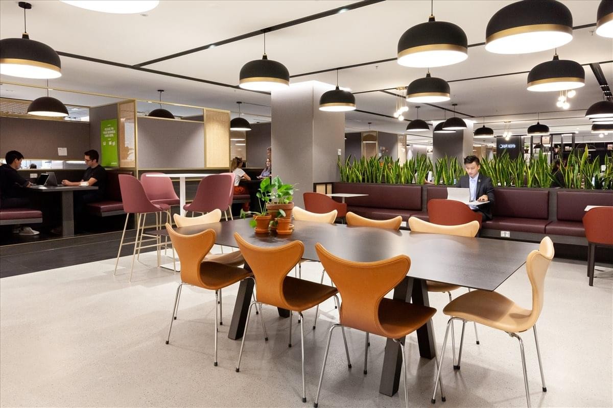 Spacious dining and lounge area at Lan Kwai Fong Tower with diverse seating and pendant lighting.
