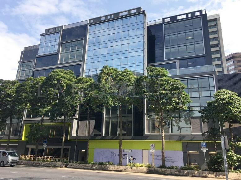 Exterior facade of the glass-paneled Mega Cube building with street-level trees.