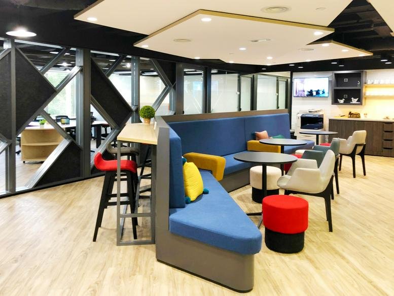 Spacious communal lounge with colorful modular seating and modern lighting at Silvercord Tower 2.