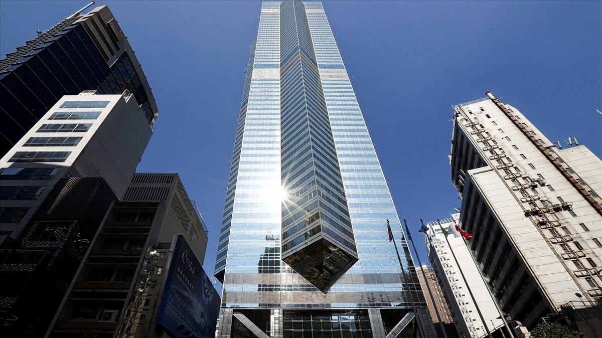 Wide-angle exterior view of the iconic skyscraper against a clear blue sky.