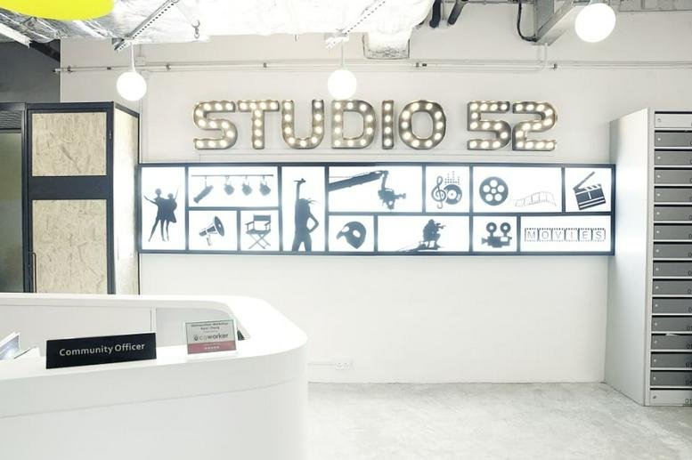 Bright reception area at The Galaxy with a white desk and decorative film-themed wall art.