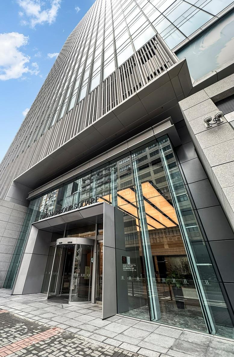 Ground level exterior view of the glass entrance at Two Harbour Square.