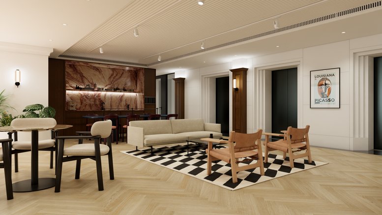 Spacious communal lounge at 9 Queen's Road Central featuring warm lighting, mid-century chairs, and a geometric rug.