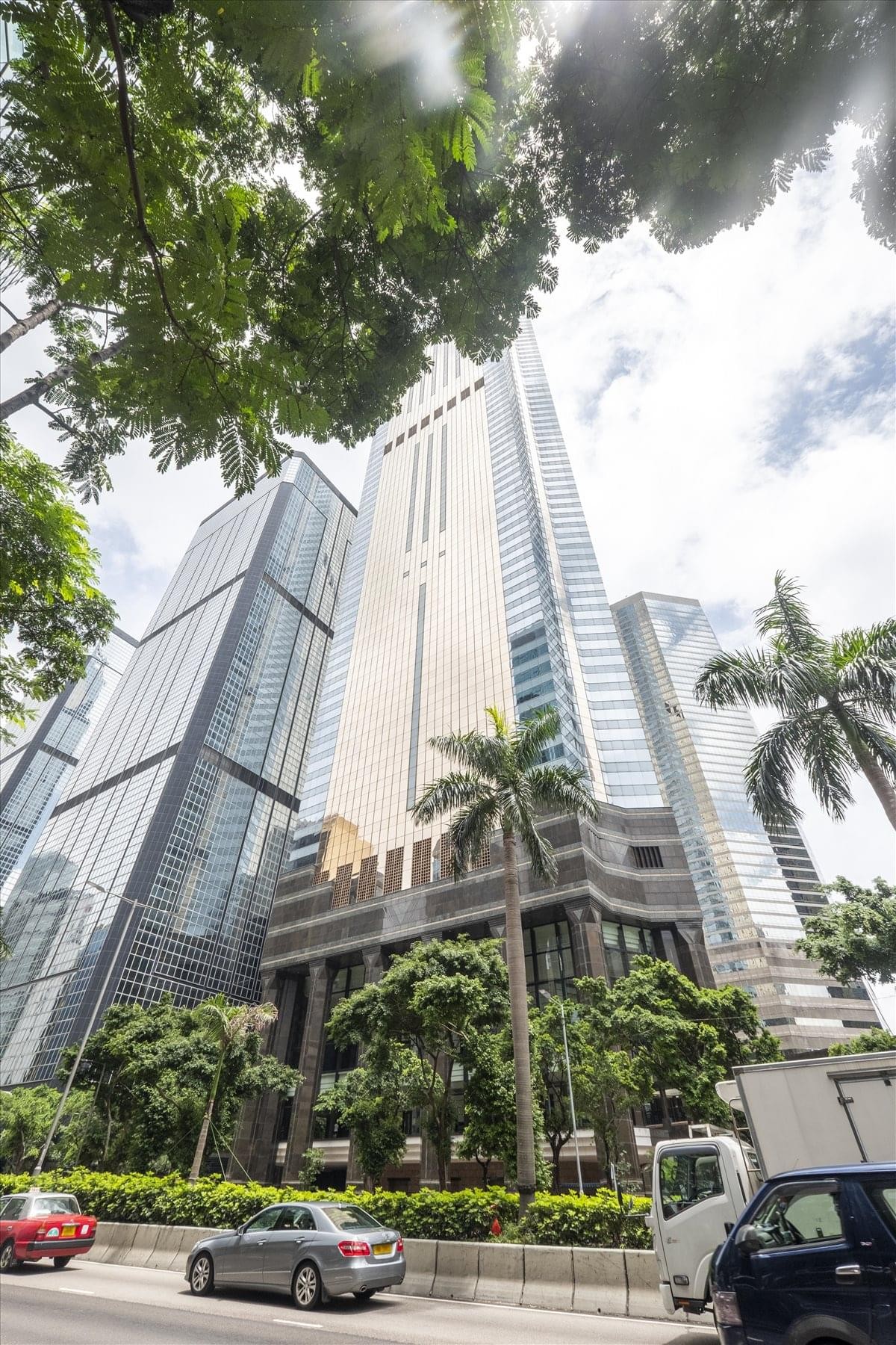 Low angle exterior view of the towering glass and stone facade of Central Plaza, 18 Harbour Road, Wanchai.