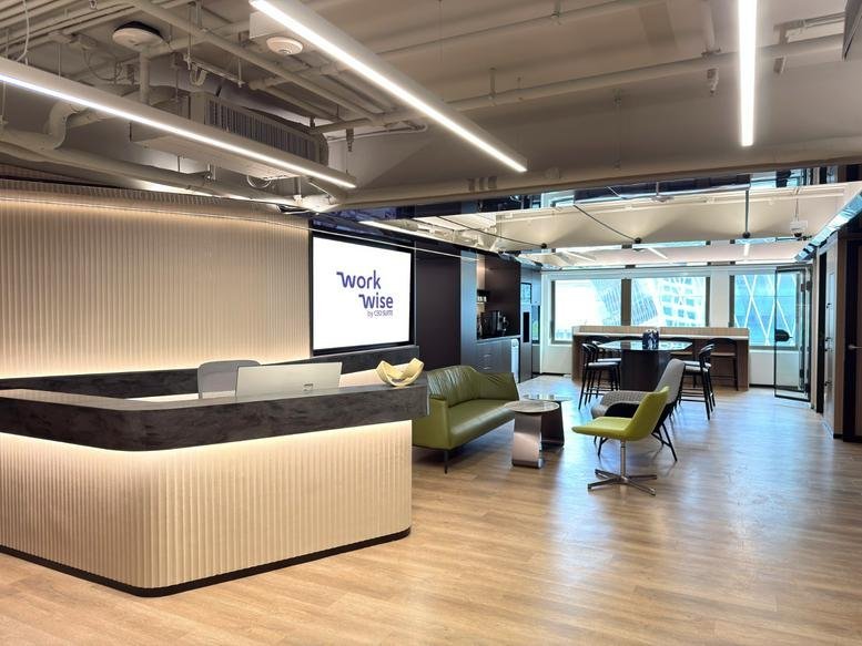 Bright reception area at Chinachem Tower featuring a curved backlit desk and a lime green sofa.