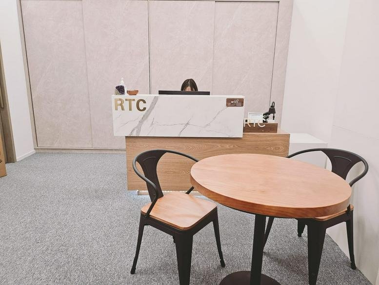 Reception area at First Group Centre featuring a marble-fronted desk and cafe seating.