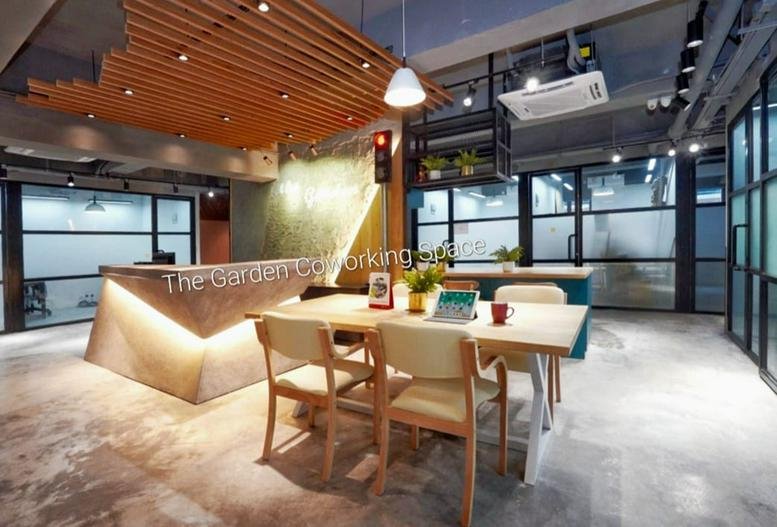 Modern wooden reception desk at Tai Cheong Fty Bldg with slatted ceiling and warm accent lighting.