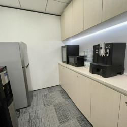 Office pantry area with coffee machine and storage cabinets, Lippo Sun Plaza, Tsim Sha Tsui, Hong Kong.